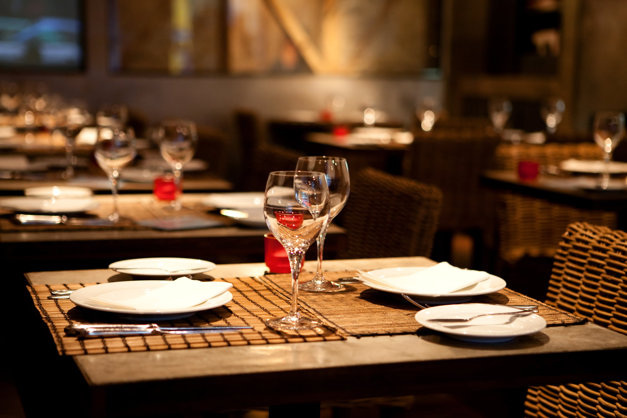 a set table at a restaurant in dim lighting